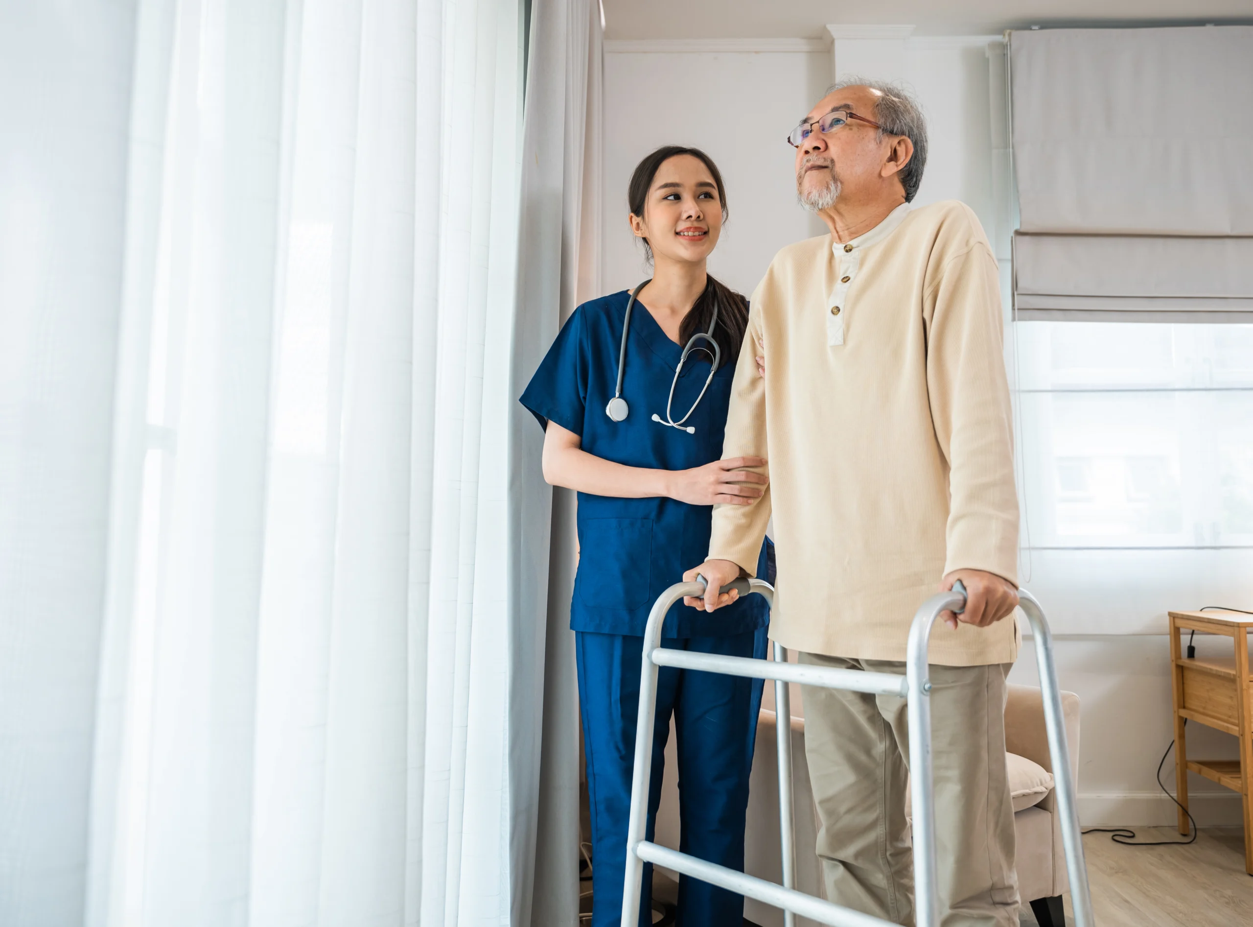 asian-nurse-her-senior-old-man-client-walking-frame-medical-healthcare-tools-looking-out-window-woman-doctor-support-medical-care-elderly-patient-hospital-room