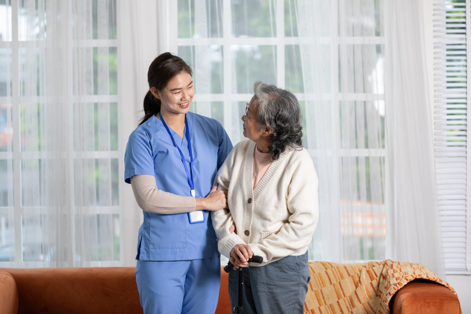 happy-asian-female-doctor-helping-elderly-patient-walking-with-cane-walking-stick-homenures-caregiver-assistance-support-senior-patient-trying-walk-with-safety-cheerful-encouraged